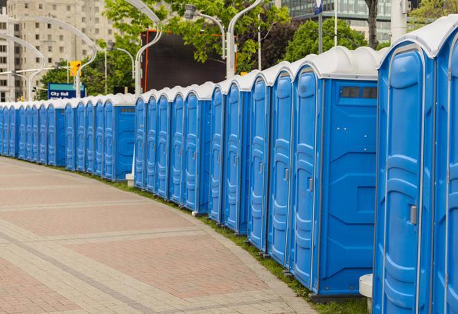 a row of sleek and modern portable restrooms at a special outdoor event in Elkhorn